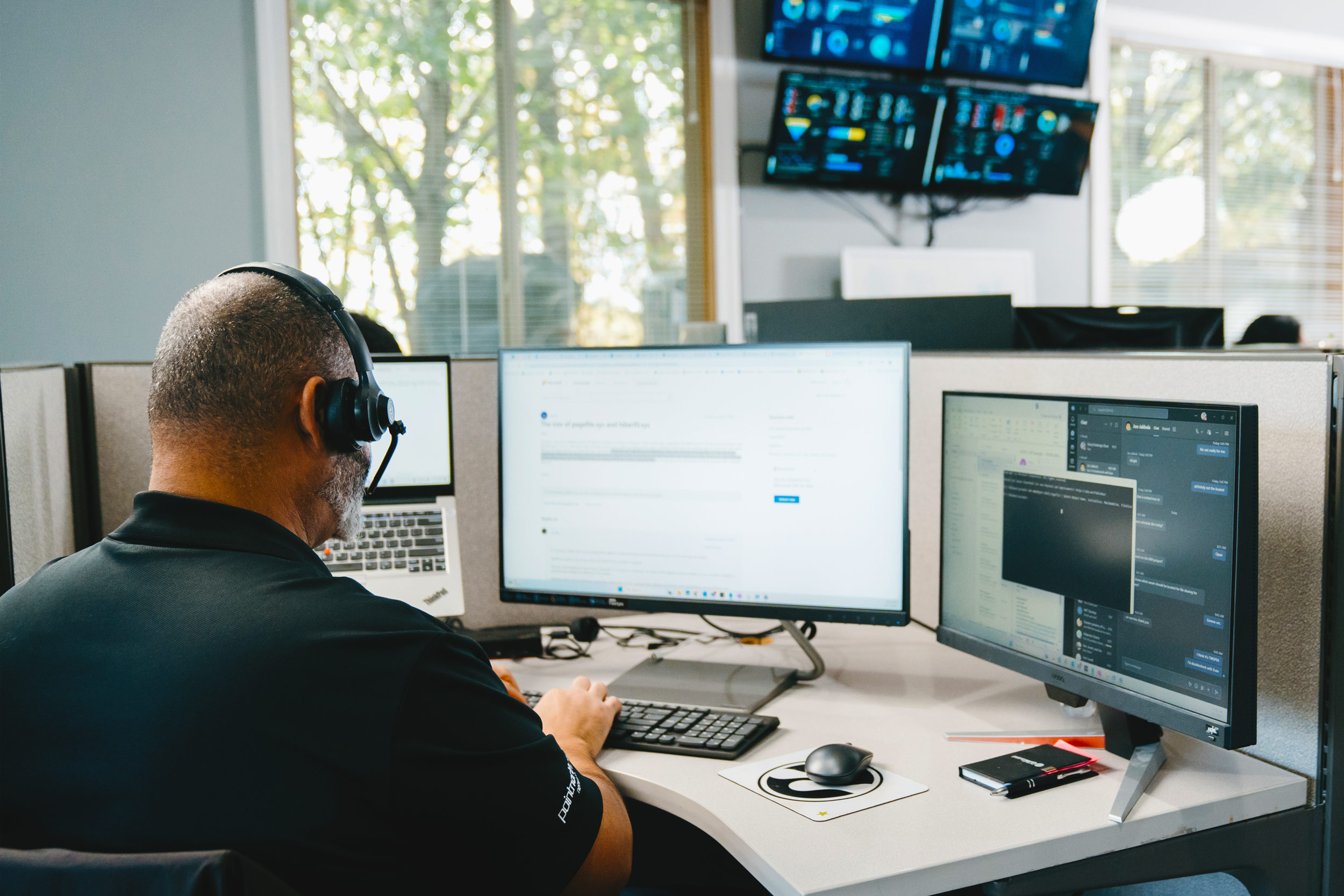 Man working on computer at his desk at Point North Networks